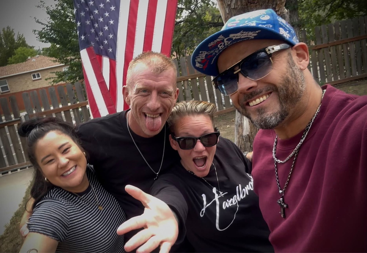 Group photo of Patrick Quezada with coworkers at a sober living home